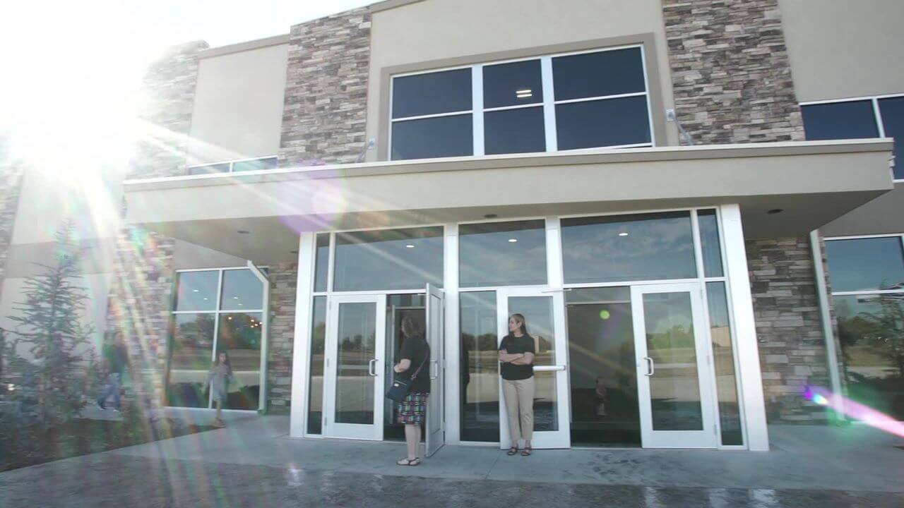 a group of people standing outside of a building